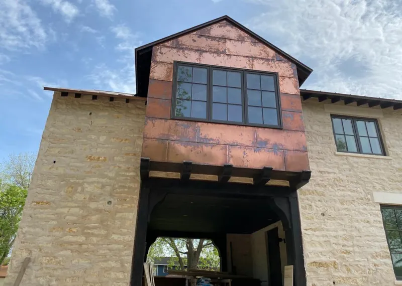 Copper metal panel facade on a stone building for Skylight Installation in Griffin